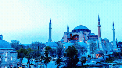 A Large Building With A Dome And A Few Minaret 'S In Front Of It GIF