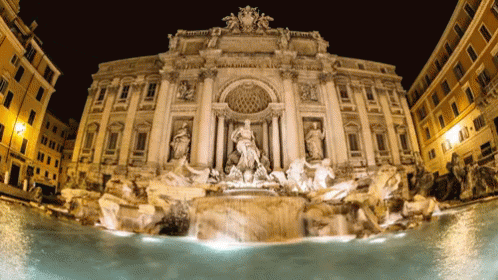 A Large Building With A Fountain In Front Of It That Says ' Pompeii ' On The Top GIF