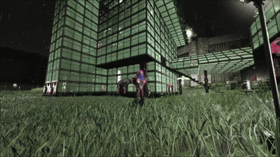 A Large Building With A Lot Of Windows Is Lit Up At Night And A Person Is Standing In Front Of It GIF