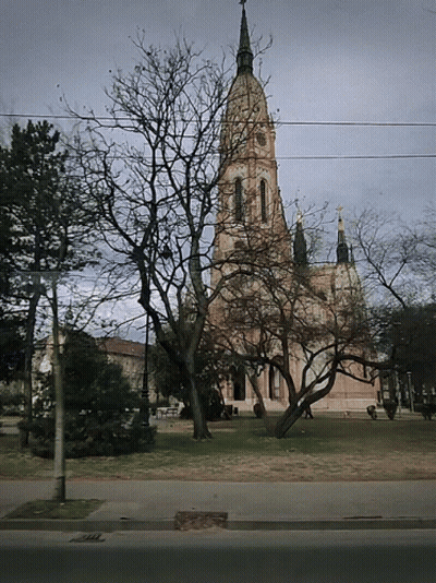 A Large Building With A Steeple And A Cross On Top GIF