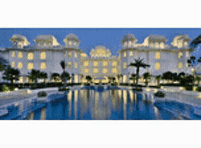 A Large Building With A Swimming Pool In Front Of It GIF