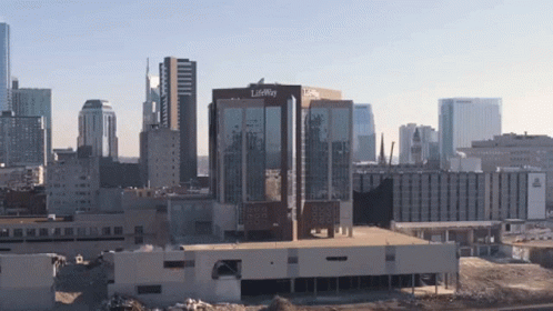 A Large Building With The Word Lifeway On It Is In The Middle Of A City GIF