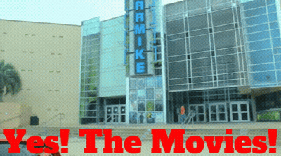 A Large Building With The Words Yes The Movies Written On It GIF