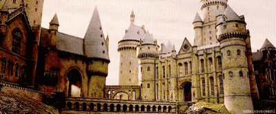 A Large Castle With A Bridge In Front Of It And A Caption That Says ' Harry Potter Hogwarts ' GIF