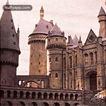 A Large Castle With A Clock On The Top Of It And The Words Kulfyapp.com At The Bottom GIF