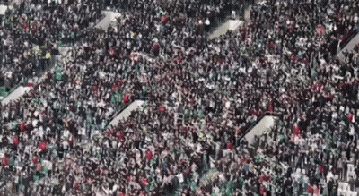 A Large Crowd Of People Are Gathered In A Large Stadium GIF