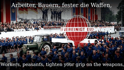 A Large Crowd Of People Are Gathered In Front Of A Sign That Says " Arbeiter Bauern Fester Die Waffen " GIF