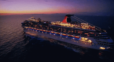 A Large Cruise Ship With The Word Carnival On The Side GIF