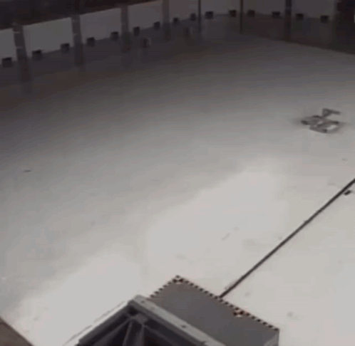 A Large Empty Room With A White Floor GIF