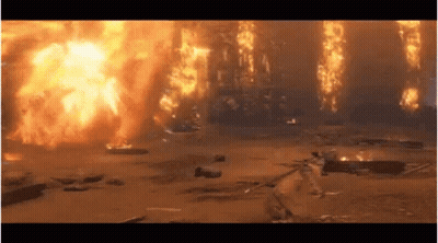 A Large Explosion Is Taking Place In A Field With A Lot Of Fire Coming Out Of It . GIF