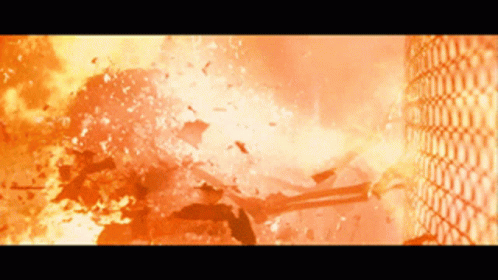 A Large Explosion With A Chain Link Fence Visible In The Background GIF