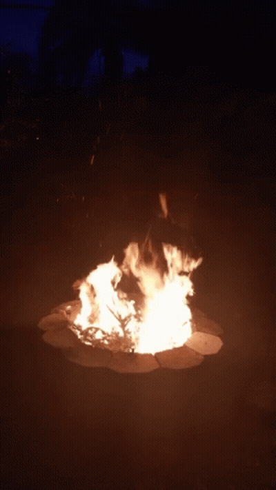 a large fire is burning in a dark area