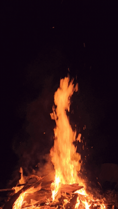 A Large Fire Is Burning In The Dark With Lots Of Flames GIF