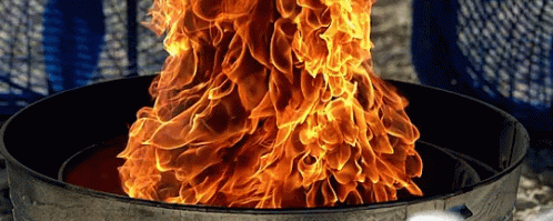 A Large Fire Is Coming Out Of A Metal Container GIF