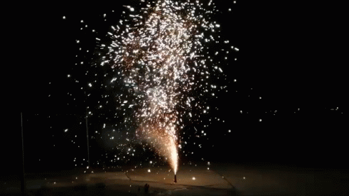 A Large Fireworks Display Is Going Off In The Night Sky GIF