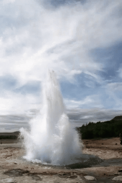 A Large Geyser Is Erupting In The Middle Of A Desert GIF