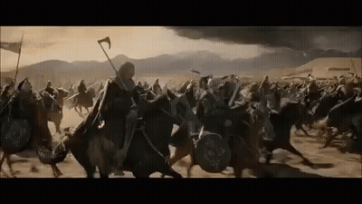 A Large Group Of Medieval Soldiers Are Riding Horses In A Field . GIF