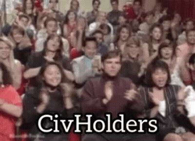 A Large Group Of People Are Clapping And Applauding In A Room . GIF