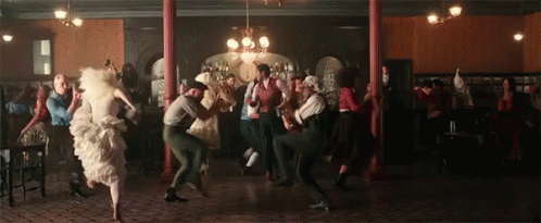 A Large Group Of People Are Dancing In A Room GIF