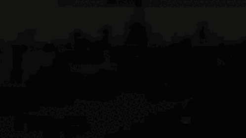 A Large Group Of People Are Gathered In Front Of A Large Building GIF