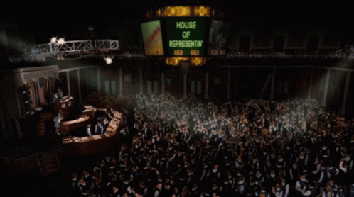 A Large Group Of People Are Gathered In Front Of A Sign That Says House Of Representatives GIF