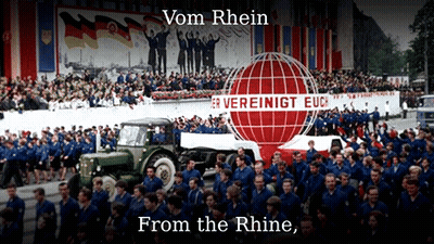 A Large Group Of People Are Gathered In Front Of A Sign That Says Vom Rhein From The Rhine GIF