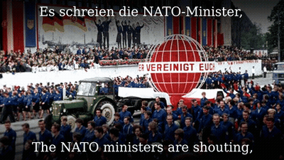 A Large Group Of People Are Marching In Front Of A Sign That Says " Es Schreien Die Nato-Minister " GIF