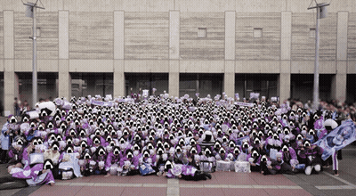 A Large Group Of People Are Posing For A Picture In Front Of A Large Building GIF