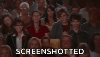 A Large Group Of People Are Sitting In A Theater Watching A Movie And The Words `` Screenshotted '' Are Displayed . GIF
