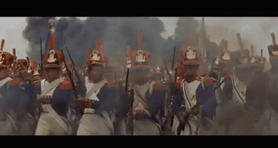 A Large Group Of Soldiers Are Marching In A Line With Their Guns In Their Hands . GIF