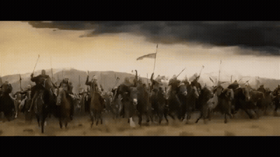 A Large Group Of Soldiers Are Riding Horses Through A Desert . GIF