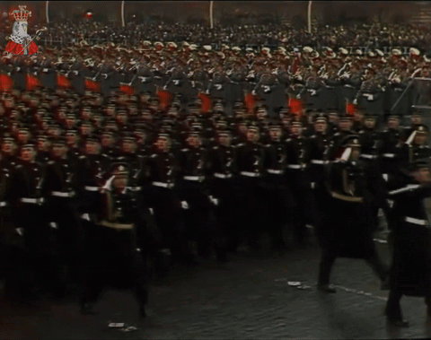 A Large Group Of Soldiers March In A Parade With The Number 7 In The Middle GIF