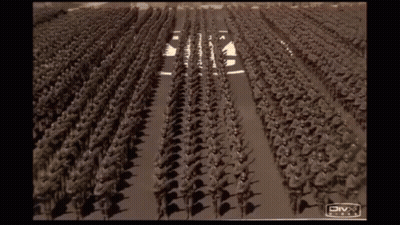 A Large Group Of Soldiers Marching Down A Street With A Divx Logo On The Bottom GIF