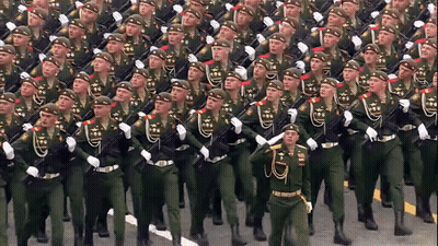 A Large Group Of Soldiers Marching In A Parade GIF
