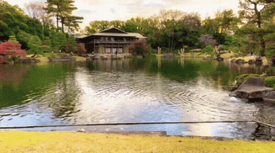 A Large House Sits On The Shore Of A Large Lake GIF