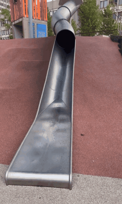 A Large Metal Slide Is Going Down A Red Carpet GIF