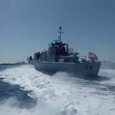 A Large Military Ship Is Going Through The Ocean GIF