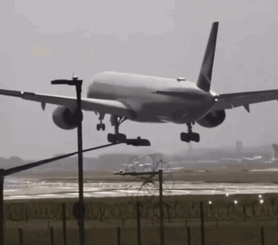 A Large Passenger Jet Is Taking Off From A Runway GIF