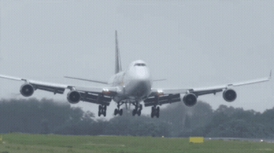 A Large Passenger Jet Is Taking Off From A Runway GIF