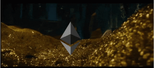 A Large Pile Of Gold Is Being Poured Into A Dark Room GIF