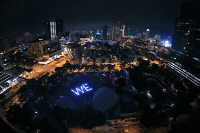 A Large Purple Ready Sign Is Lit Up In A City GIF