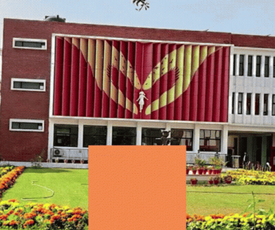 A Large Red Building With A Statue Of A Woman On The Front GIF