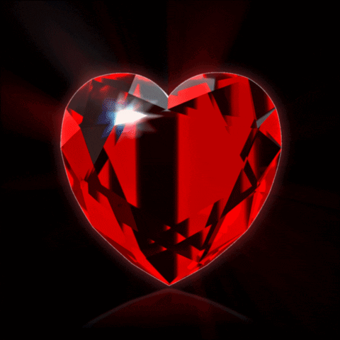 A Large Red Heart Shaped Diamond With A Black Background GIF