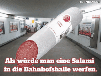 A Large Salami In A Subway With The Words " Als Wurde Man Eine Salami In Die Bahnhofshalle Werfen " Below It GIF