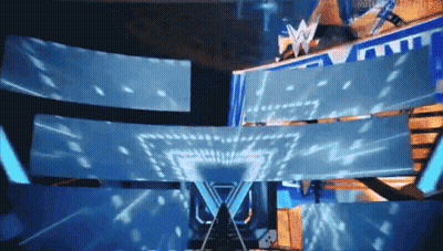 A Large Screen With The Letter W On It Is Projected On A Stage GIF