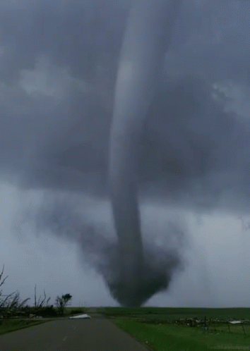 A Large Tornado Is Coming Down A Road GIF