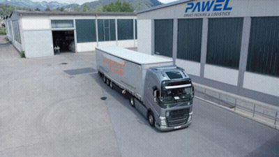 A Large Truck Is Parked In Front Of A Building That Says Pawel GIF