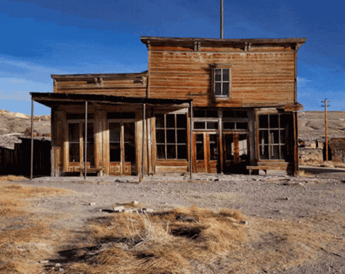 A Large Wooden Building With A Blue Sky In The Background GIF