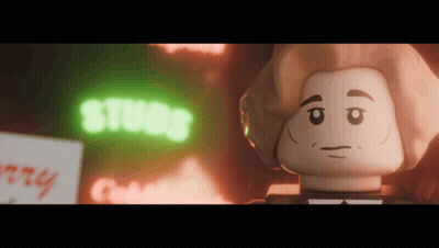 A Lego Character Is Standing In Front Of A Neon Sign That Says Studs GIF