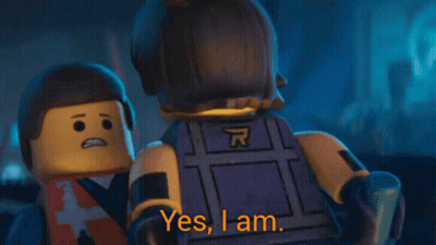 A Lego Man Says " Yes I Am " While Wearing A Vest With The Letter A On It GIF